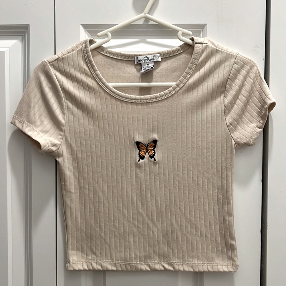 Tan top with butterfly in center